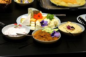 a table topped with bowls of different types of food at Prinz Gregor in Braşov