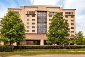 a building with trees in front of it at Embassy Suites by Hilton Nashville South Cool Springs in Franklin