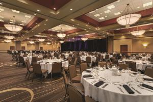 a banquet hall with white tables and chairs and chandeliers at Embassy Suites by Hilton Nashville South Cool Springs in Franklin