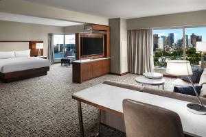 a hotel room with a bed and a television at Hilton Boston Logan Airport in Boston