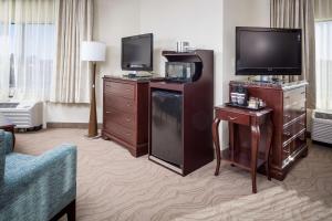 a hotel room with a television and a living room at DoubleTree by Hilton Boston-Milford in Milford