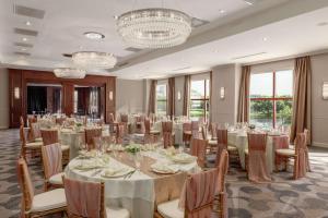 a banquet room with tables and chairs and chandeliers at DoubleTree Suites by Hilton Hotel Boston - Cambridge in Boston