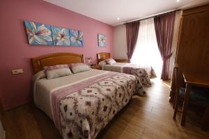 a bedroom with two beds and a piano at LUZ DE PRADA in Puebla de Sanabria