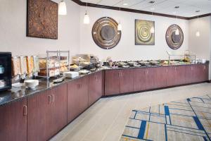 a kitchen with wooden cabinets and plates on the counter at DoubleTree by Hilton Baltimore - BWI Airport in Linthicum Heights