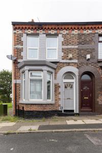 a brick house with a white door and windows at Woodbine House - Air Host and Stay - Free parking - Contractor Friendly in Liverpool