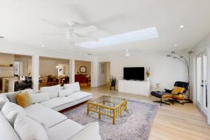 a living room with a white couch and a coffee table at Modern Oasis in Sarasota