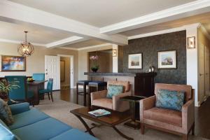 a living room with a blue couch and chairs at Hilton Columbia Center in Columbia