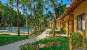 a house with a swimming pool next to a resort at Fradissimo Hotel in Angra dos Reis