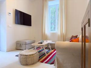 a living room with a couch and a table at VILLA CLAVERO FOUR Premium Apt in Málaga