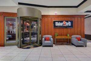 a lobby with two chairs and a sign on a wall at Hilton Garden Inn Chicago Downtown/Magnificent Mile in Chicago