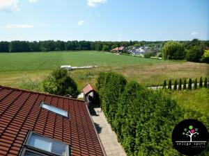 an aerial view of a field and a house with a roof at Seliga Sport Apartments in Lesznowola