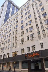 un gran edificio blanco con un cartel. en Rede Andrade San Martin, en Curitiba