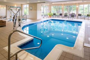 a swimming pool in a hotel lobby with a lap pool at Hilton Garden Inn Charlottesville in Charlottesville