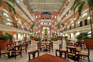 a restaurant with tables and chairs in a building at Embassy Suites Charleston - Historic District in Charleston