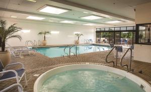 a pool in a hotel room with a hot tub at DoubleTree by Hilton Chicago - Oak Brook in Oak Brook