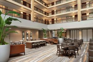 a rendering of the lobby of a hotel with tables and chairs at Embassy Suites by Hilton Cleveland Rockside in Independence