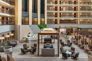 an open lobby of a building with chairs and tables at Embassy Suites by Hilton Cleveland Rockside in Independence