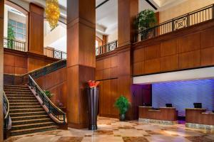 a large lobby with stairs and a large aquarium at Hilton Charlotte Uptown in Charlotte