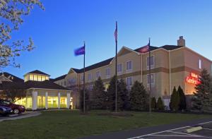 a hotel with flags in front of a building at Hilton Garden Inn Columbus Airport in Columbus