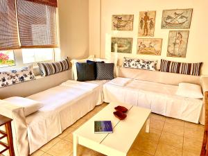 a living room with a couch and a table at Atreas’ Art Studio in Chania Town