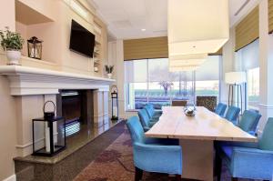a dining room with a table and chairs and a fireplace at Hilton Garden Inn Columbus Airport in Columbus