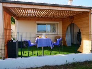 eine Terrasse mit einem Tisch und Stühlen unter einer Pergola in der Unterkunft Le Spa des lavandes in Valensole