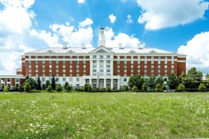 a large building with a grass field in front of it at Hilton Columbus at Easton in Columbus