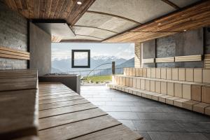a building with benches and a view of a mountain at DAS GERSTL Alpine Retreat in Malles Venosta