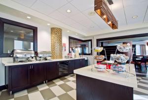 a large kitchen with a counter with some food on it at Hampton Inn & Suites Columbus-Downtown, Ohio in Columbus