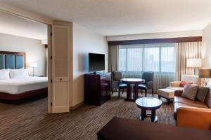 a hotel room with a bed and a living room at DoubleTree Suites by Hilton Hotel Columbus Downtown in Columbus