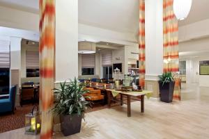 a lobby with tables and chairs in a building at Hilton Garden Inn Casper in Casper