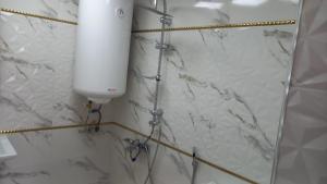 a white water tank on the wall of a bathroom at Lahij Rashad Ismayilov Hotel in Lahıc +154 photos