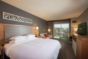 a hotel room with a large bed and a television at The Broadway Columbia - a DoubleTree by Hilton Hotel in Columbia +25 photos