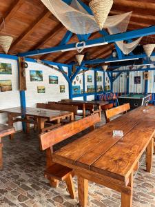 a group of wooden tables in a room at Casa Iris Murighiol in Murighiol