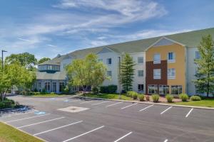 a building with a parking lot in front of it at Hilton Garden Inn Cincinnati/Sharonville in Sharonville