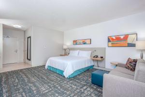 a hotel room with a bed and a couch at Hilton Garden Inn Cincinnati/Sharonville in Sharonville +34 photos