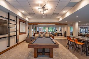 a living room with a pool table in it at DoubleTree by Hilton Dallas-Farmers Branch in Farmers Branch