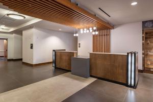 a lobby with a reception desk in a building at DoubleTree by Hilton Dallas-Farmers Branch in Farmers Branch