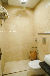 a bathroom with a toilet and a sink at Hotel Batra Home Nizamuddin in New Delhi