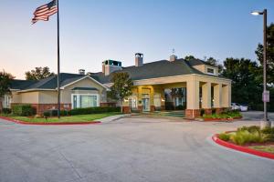 a house with an american flag in front of it at Homewood Suites by Hilton Dallas-Lewisville in Lewisville