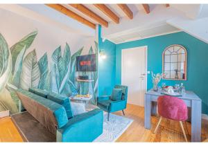 sala de estar con paredes azules, mesa y sillas en Le Cocon de la Cathédrale en Évreux