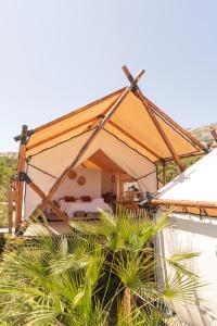 a tent with a bed and some plants at Dreamsea Mediterranean Camp in Benitachell