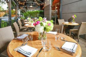 a wooden table with a vase of flowers on it at Hilton Dallas-Park Cities in Dallas