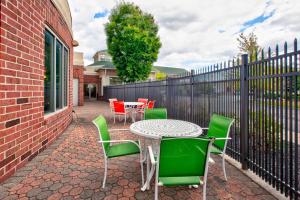 a patio with a table and chairs and a fence at Hilton Garden Inn Dayton/ Beavercreek in Beavercreek
