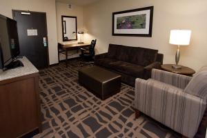 a living room with a couch and a television at Hilton Garden Inn Dayton South - Austin Landing in Springboro