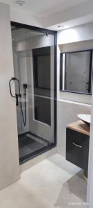 a bathroom with a glass shower with a sink at Zara at Saint Raphael France in Saint-Raphaël