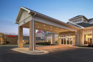 a large office building with a parking lot at Hilton Garden Inn Dubuque Downtown in Dubuque