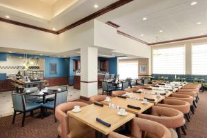 a large dining room with tables and chairs at Hilton Garden Inn Dubuque Downtown in Dubuque