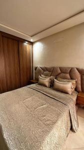 a bedroom with a large bed with two pillows at Appartement Anir in Agadir