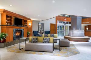 a lobby with two couches and a fireplace at Hilton Garden Inn Tysons Corner in Tysons Corner